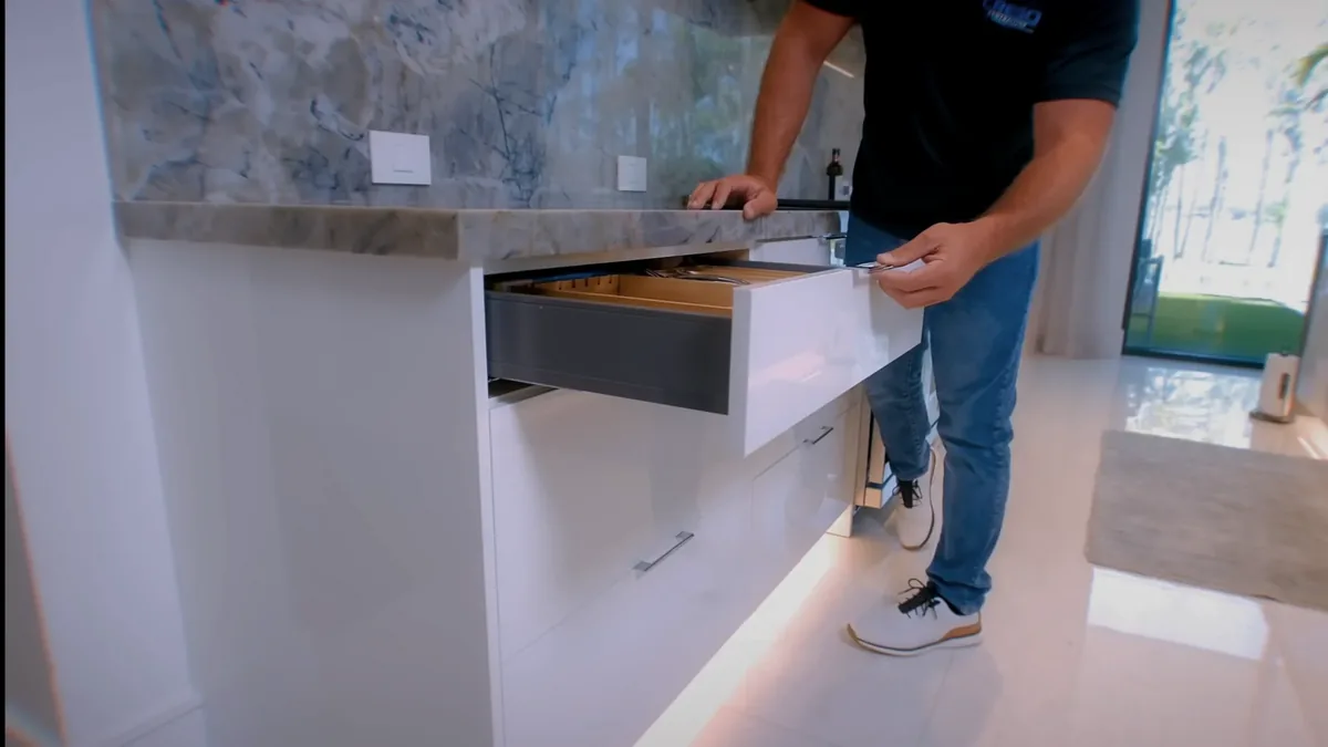 Full-extension soft-close drawer with a wood organizer insert in a custom kitchen base cabinet by Crego Contracting, serving Hudson, FL
